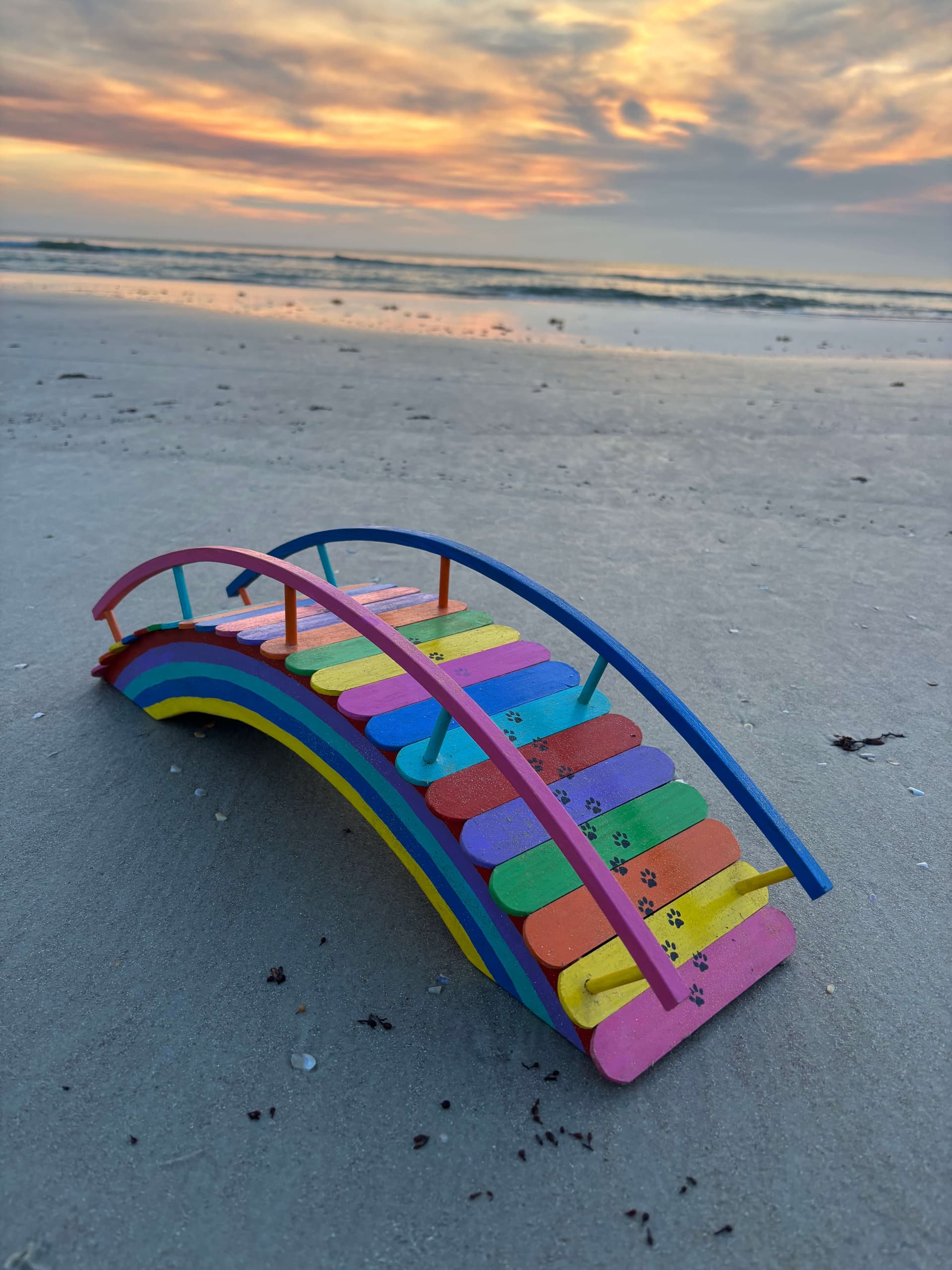 One of Paul's rainbow bridges on the wet sand at first light, its full arch reflected