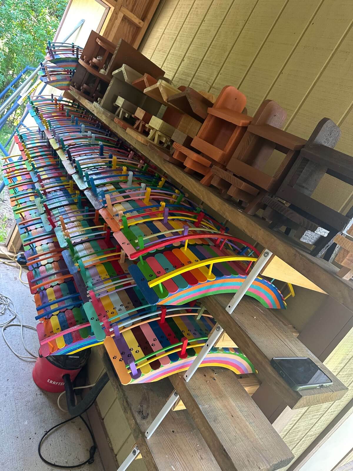 Rainbow bridges along Paul's workshop shelf with squirrel feeders