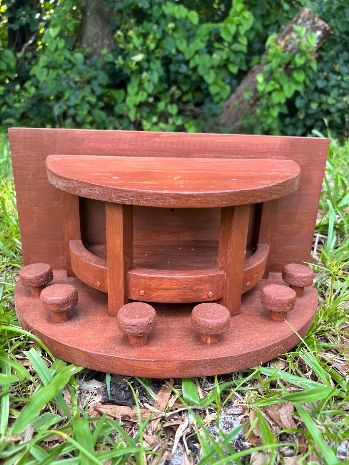 A brown handcrafted squirrel feeder by Paul Allabaugh