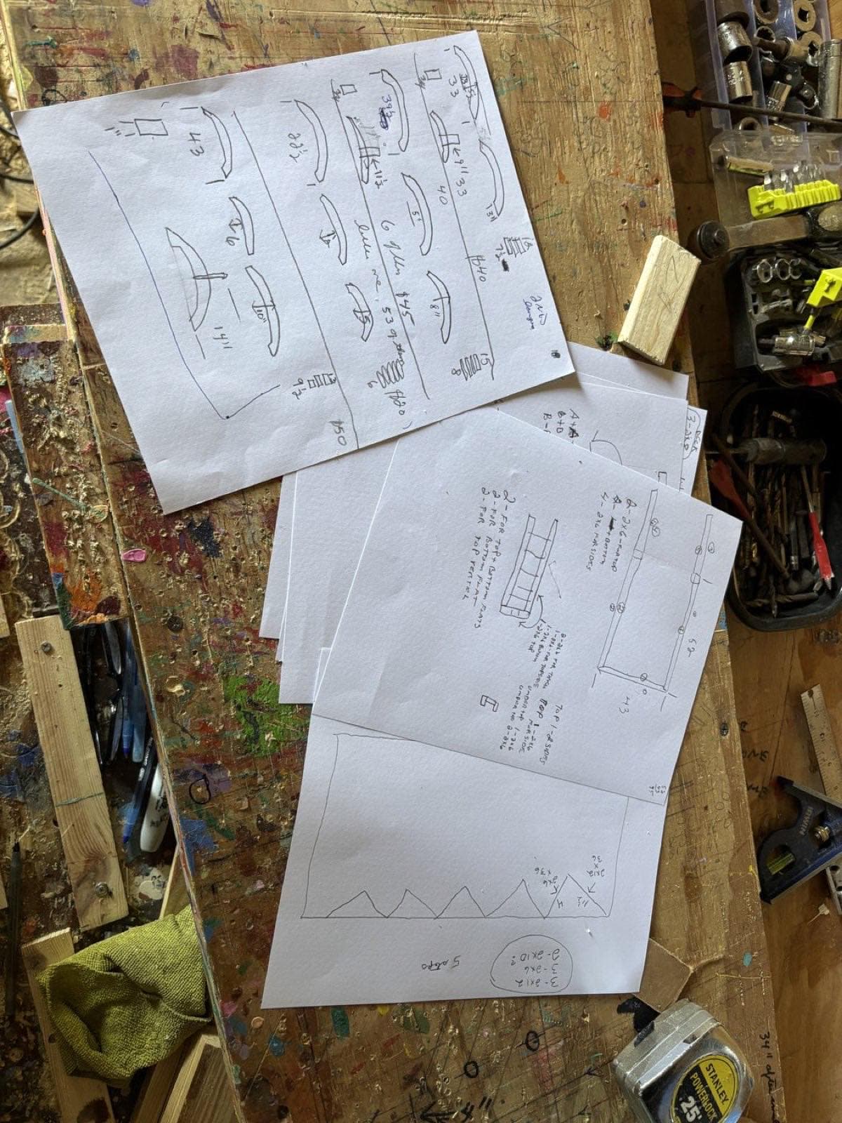 Paul Allabaugh's overlapping bridge sketches on his workbench