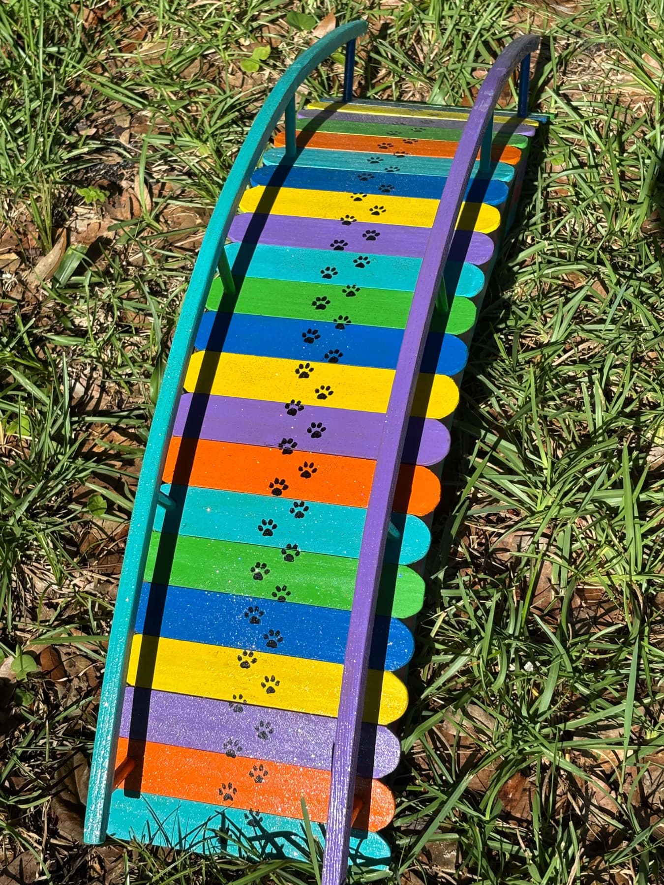 Looking down the deck of a Rainbow Bridge, paw prints crossing it